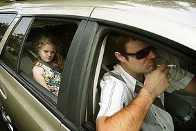 Smoking in vehicles with children is unacceptable - windows open or closed.